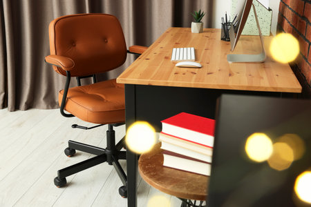 Comfortable office chair near desk at workplaceの写真素材