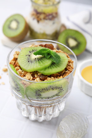Delicious dessert with kiwi and muesli on white table, closeupの写真素材
