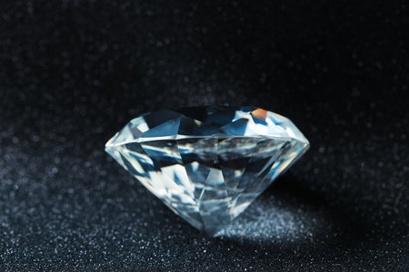 Beautiful dazzling diamond on shiny glitter background, closeup. Precious gemstoneの写真素材