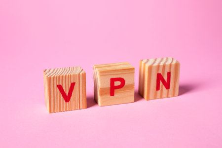 Wooden cubes with acronym VPN on pale pink backgroundの写真素材