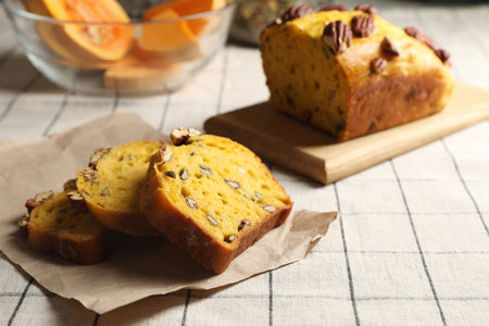 Delicious pumpkin bread with pecan nuts on tableclothの写真素材