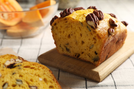 Delicious pumpkin bread with pecan nuts on tablecloth, closeupの写真素材
