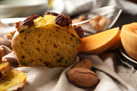 Delicious pumpkin bread with pecan nuts on tablecloth, closeupの写真素材