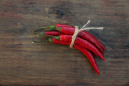 Fresh ripe chili peppers on wooden table, flat layの写真素材