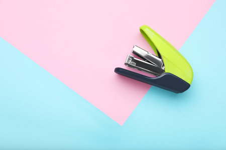 New bright stapler on color background, top view. Space for textの写真素材