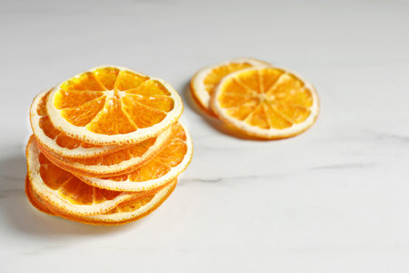 Dry orange slices on white table, space for textの写真素材