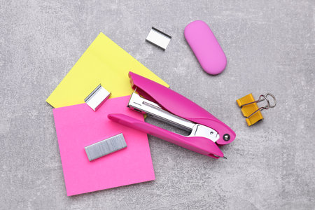 Flat lay composition with new stapler on gray table