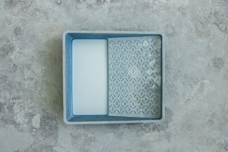 Container with white paint on floor, top viewの写真素材