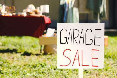 Sign Garage sale written on cardboard in yard, closeup. Space for textの写真素材
