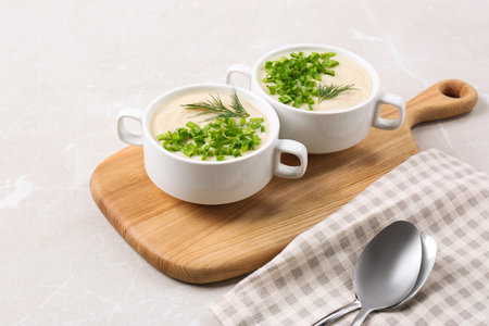 Bowls with tasty creamy soup of parsnip served on light gray backgroundの写真素材