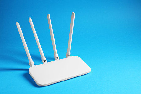 New white router on blue background, space for text
