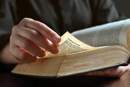 Woman reading Bible on wooden table, closeupの写真素材