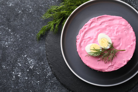 Herring under fur coat salad on gray table, top view with space for text. Traditional Russian dishの写真素材