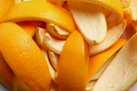 Orange peels preparing for drying on white wooden table, closeupの写真素材