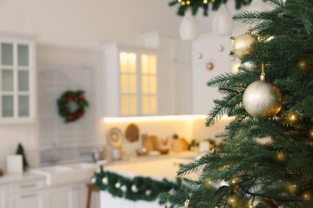 Closeup view of beautiful decorated Christmas tree in kitchen. Space for textの写真素材