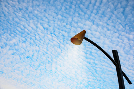 Street lamp against blue cloudy sky. Space for textの写真素材
