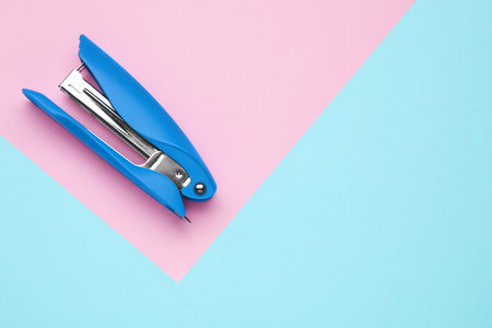 New bright stapler on color background, top view. Space for textの写真素材