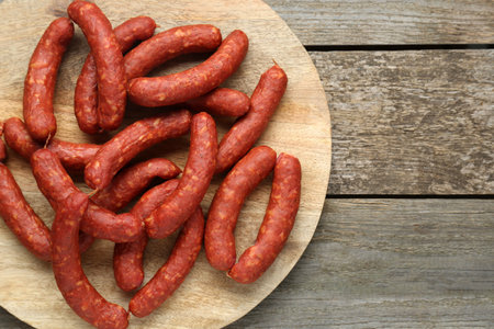 Delicious sausages on wooden table, top view. Space for textの写真素材