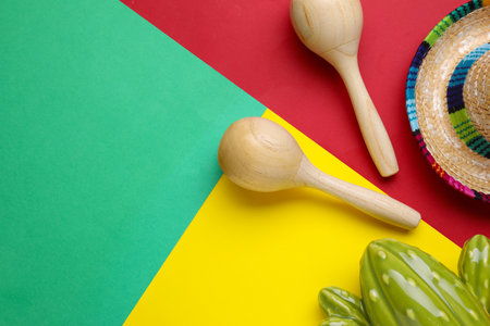 Maracas, toy cactus and sombrero hat on colorful background, flat lay with space for text. musical instrumentsの写真素材