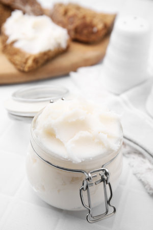 Delicious pork lard in glass jar on white table, closeupの写真素材