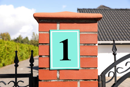 Number 1 on red brick column near house outdoorsの写真素材