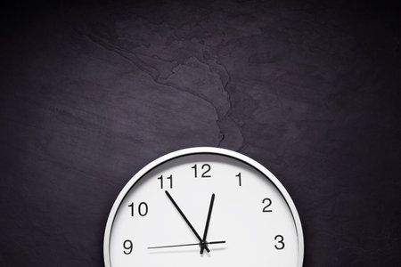 Stylish round clock on black table, top view with space for text. interior elementの写真素材