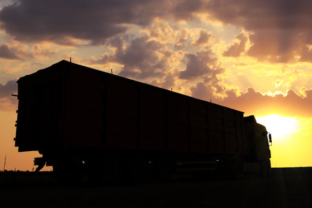 Truck parked on country road at sunsetの写真素材