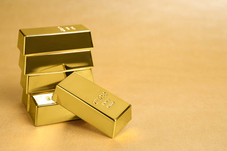 Many shiny gold bars on color background. Space for text