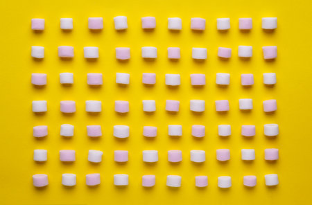 Delicious marshmallows on yellow background, flat lay