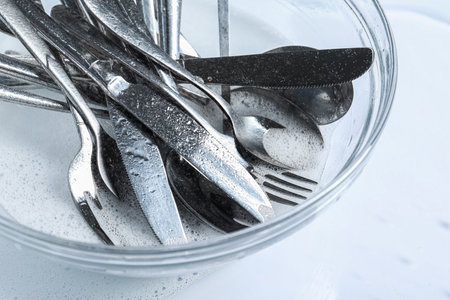 Glass bowl with silverware in foam, above viewの写真素材