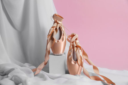 ballet shoes. Stylish presentation of elegant pointes on pink backgroundの写真素材