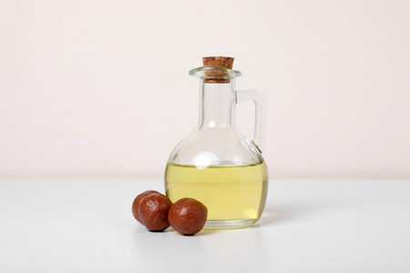 Delicious organic Macadamia nuts and natural oil on white backgroundの写真素材