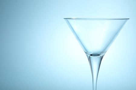 Elegant empty martini glass on light blue background, closeup. Space for textの写真素材