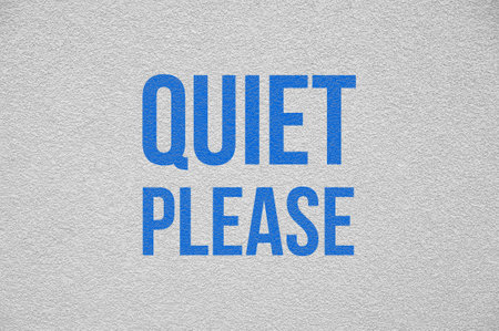 Phrase Quiet Please on white textured wallの写真素材