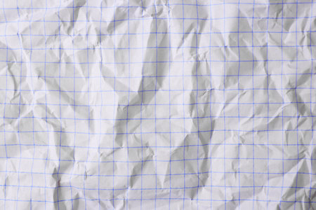 Sheet of crumpled checkered paper as background, top viewの写真素材