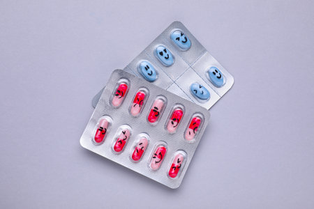 Different antidepressants with emoticons on gray background, flat layの写真素材