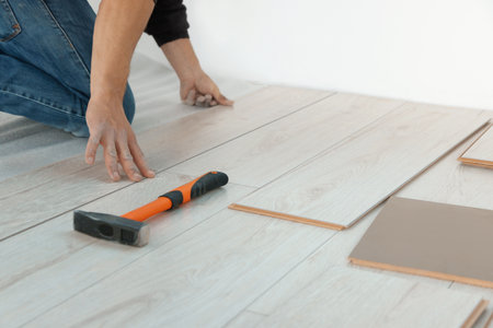 Worker installing new laminate flooring in room, closeupの写真素材