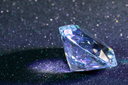 Beautiful dazzling diamond on glitter background, closeup. Space for textの写真素材