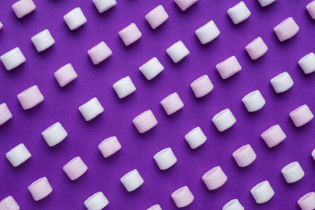 Delicious marshmallows on purple background, flat layの写真素材