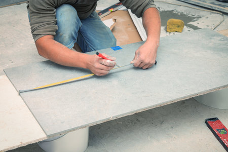 Worker making socket hole in tile indoors, closeupの写真素材