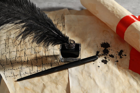 Inkwell with feather, fountain pen and vintage parchmentの写真素材