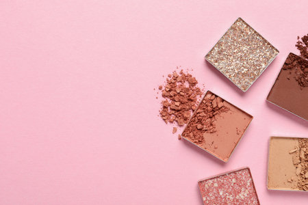 Crushed eye shadows on pink background, flat lay with space for text. professional makeup productの写真素材