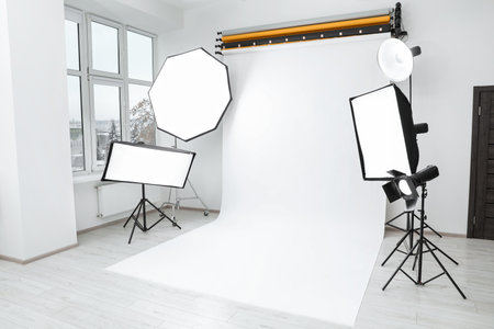 Interior of modern photo studio with professional lighting equipment