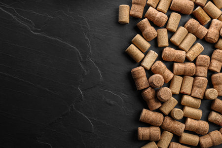 Wine bottle corks on black table, flat lay. Space for textの写真素材