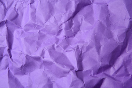 Sheet of crumpled violet paper as background, top viewの写真素材