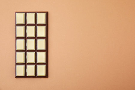 Tasty chocolate bar on brown background, top view. Space for textの写真素材