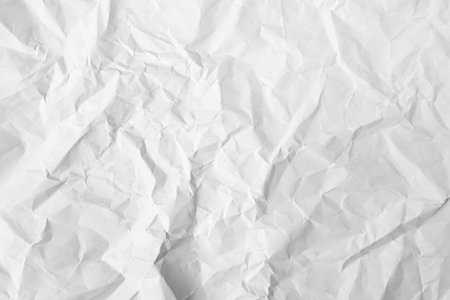 Sheet of crumpled paper white as background, top viewの写真素材