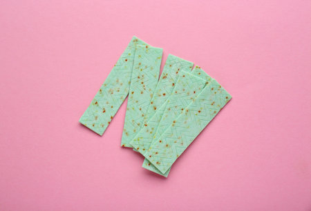 Many sticks of tasty chewing gum on pink background, flat lay