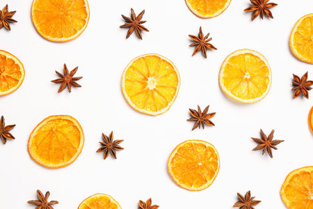 Dry orange slices and anise stars on white background, flat layの写真素材
