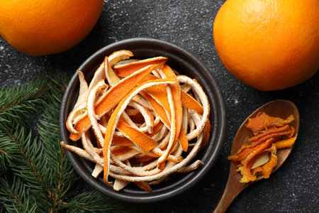 Dry peels, oranges and fir branch on gray textured table, flat layの写真素材